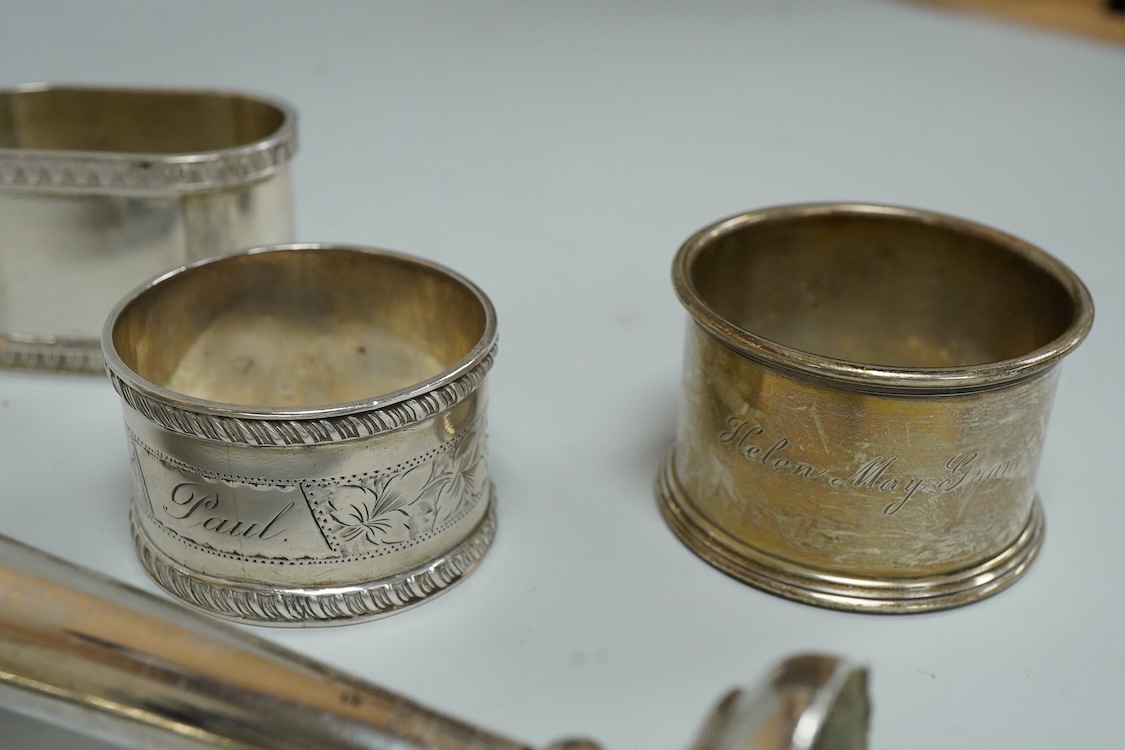 Three assorted silver napkin rings, a pair of recent 925 napkin rings, a George V silver mounted hand mirror, a modern silver mounted spill vase and a late Victorian silver vesta case.